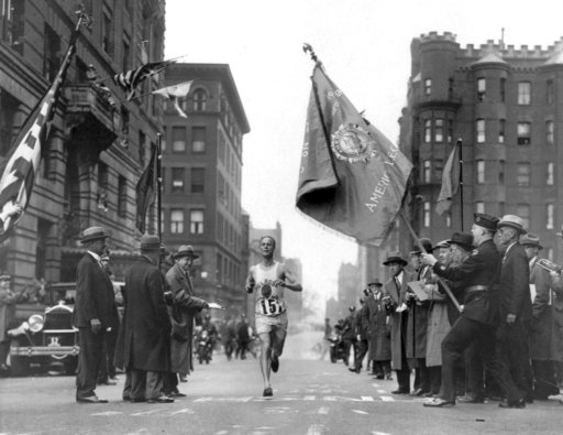 FILE - In this April 19, 1930 file photo, veteran marathoner Clarence DeMar, of the Melrose American Legion Post, crosses the finish line to win the Boston Marathon in the last of his record seven wins in Boston. A new film that captures much of the Boston Marathon's colorful history premieres Saturday, April 15, 2017, in conjunction with the 121st running of the race on Monday. (AP Photo, File)