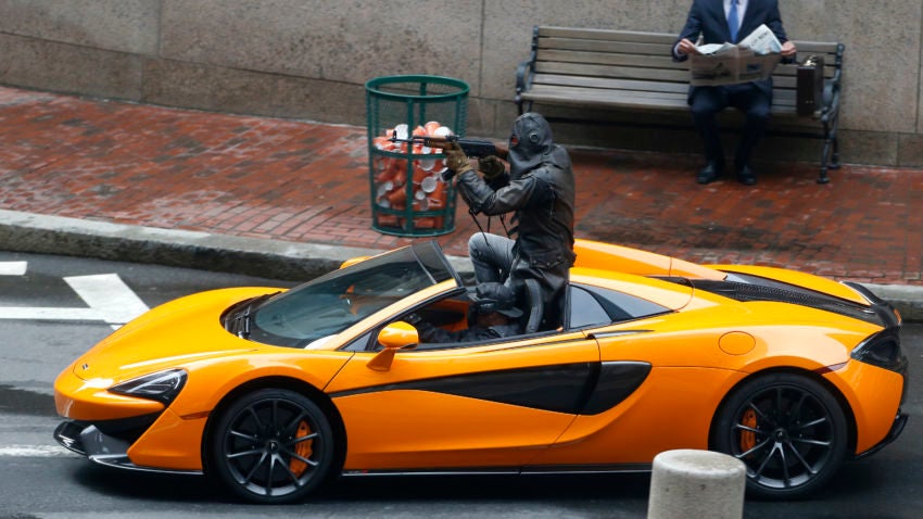 Actors perform a bank robbery scene in Liberty Square for “Free Guy.”	—Jessica Rinaldi/Globe Staff 