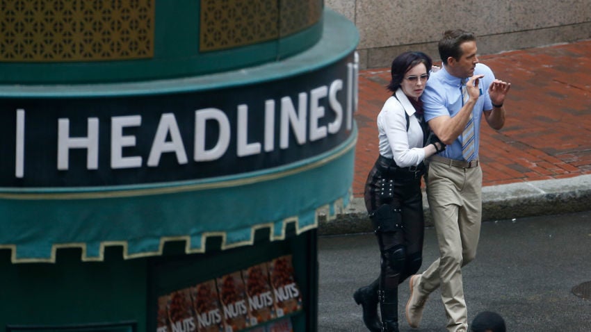 Jodie Comer and Ryan Reynolds film a scene for "Free Guy" in Boston's Liberty Square.	–Jessica Rinaldi/Globe Staff